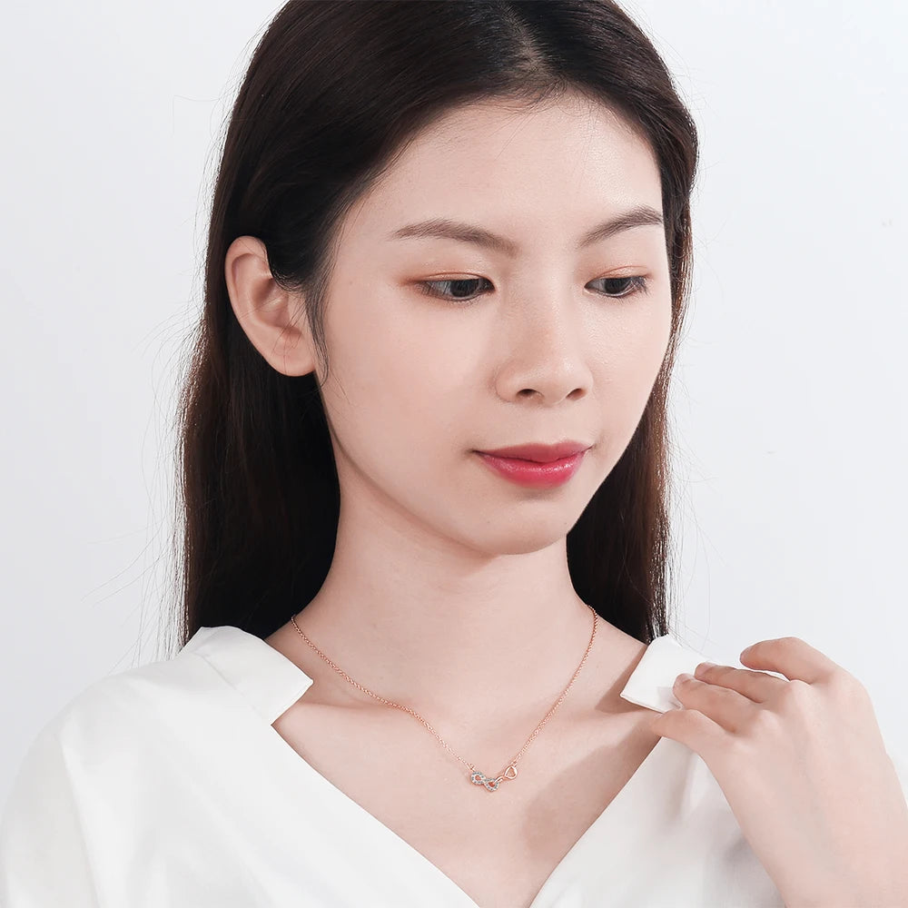 Κολιέ με διπλό μενταγιόν άπειρο και ζιργκόν ροζ χρυσό